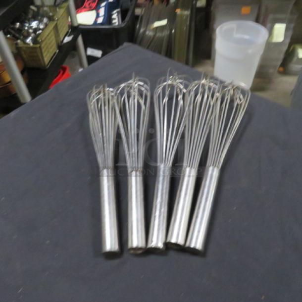 Set of four stainless steel whisks, model 5XBID, in used condition, perfect for kitchen mixing tasks.