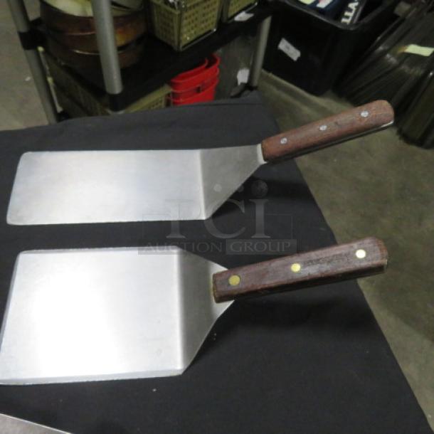 Assorted commercial hamburger turners with wooden handles, metal blades, slightly used condition, 2XBID model.