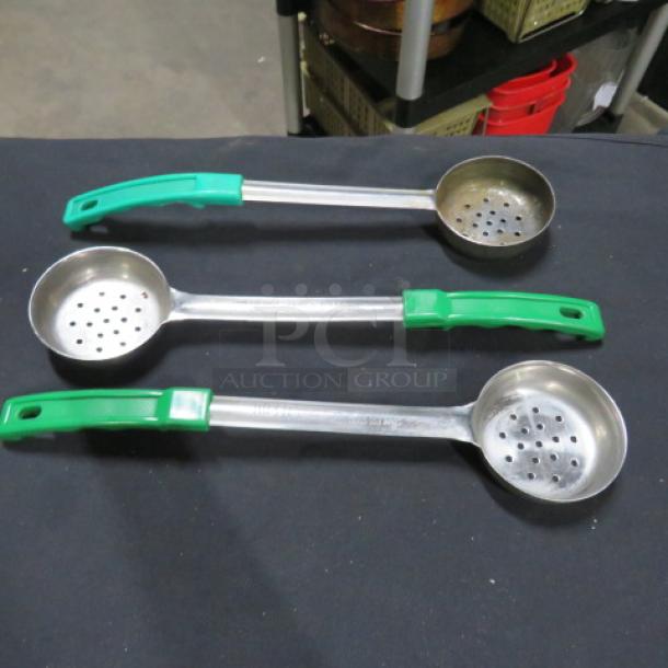 Three 4oz perforated spoodles with green handles, stainless steel construction, used condition.