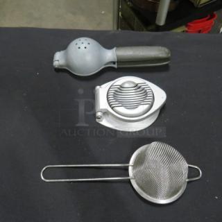 Assorted kitchen utensils: metal lemon squeezer, egg slicer, and wire mesh strainer. Good condition.