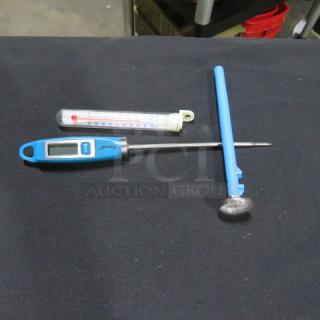 Assorted thermometers, including blue digital model with LCD display and metal probe, and analog model with protective case.