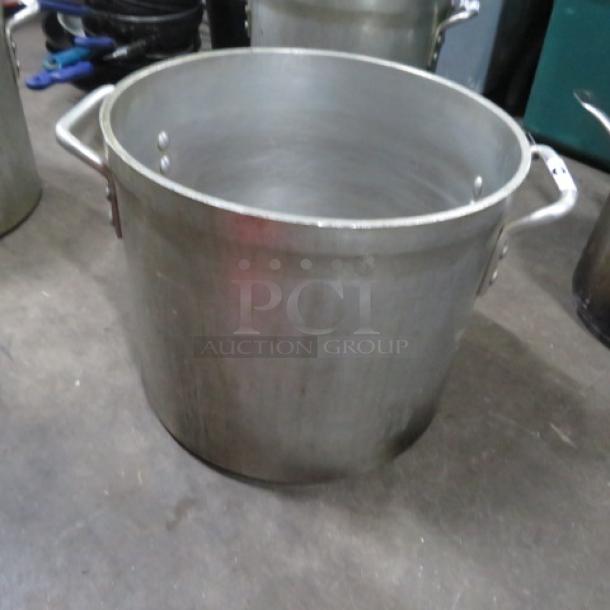 20 Quart Aluminum Stock Pot with sturdy handles. Used condition with minor scuffs. Ideal for large batch cooking.