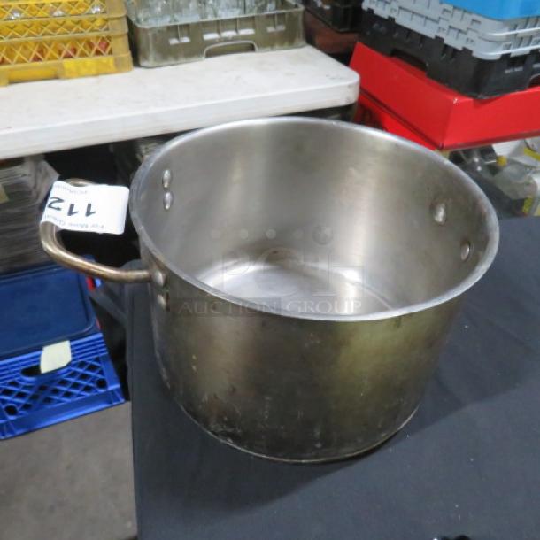 Stainless steel pot, 10x7 inches, gently used. Features sturdy handles, minor surface wear. Perfect for auction collectors.