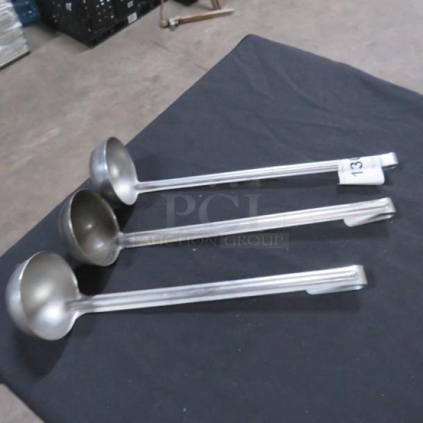 Three 4oz stainless steel ladles with long handles, in good condition, displayed on a dark cloth. Marked "3XBID 13."