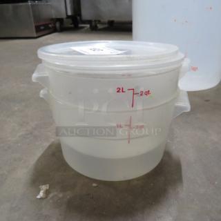 2 Quart round food storage container with lid, clear plastic, capacity markings up to 2L/2qt. Lid labeled 2XBID.