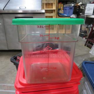 4-quart food storage container with green lid, marked with measurement indicators up to 3.5L. Appears in good condition.