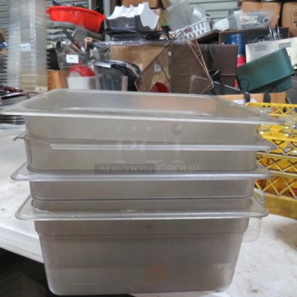 1/2 size 6-inch deep food storage containers, stack of four, clear plastic, lightly used, ideal for commercial kitchen use.