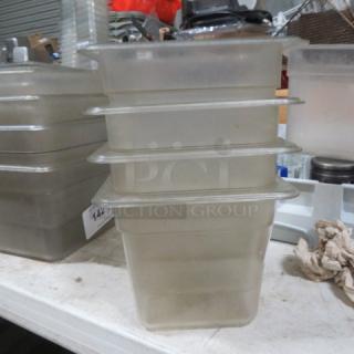 1/6 size, 6-inch deep food storage container in used condition, stacked on table. Ideal for kitchen or restaurant use.