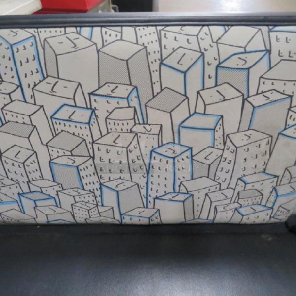 C-shaped booth with black cushioned seat and patterned cushioned back featuring geometric design.