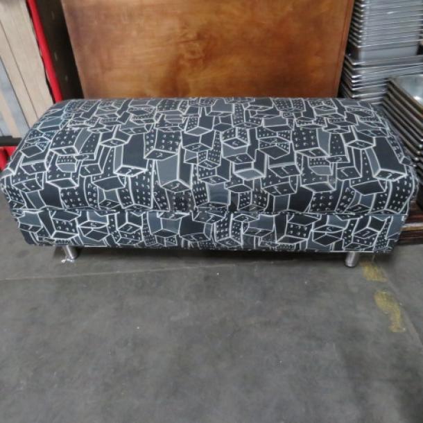 Contemporary cushioned waiting bench, 48x21x19 inches, geometric black and white upholstery, metal legs, in good condition.