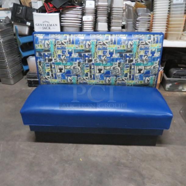 Single-sided booth with blue cushioned seat and patterned back, 48x25x36 inches. Good condition.
