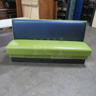Single-sided booth with cushioned seat and back, 72x25x36 inches, in blue and green upholstery, good condition.