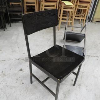 Black metal chair with wooden seat and back, model 4XBID. Minimalist design, lightly worn condition.