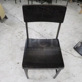 Black metal chair with wooden seat and back, model 4XBID, showing light wear, suitable for home or office use.