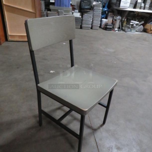 Black metal chair with gray wooden seat and back, model 4XBID. Sturdy condition, industrial design, ideal for modern décor.