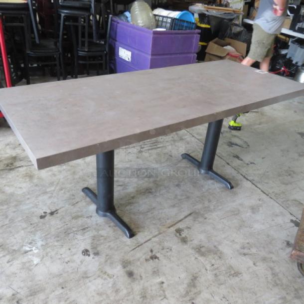 Gray table top with dual pedestal bases, measuring 72x30x30 inches, in used condition, suitable for office or home use.