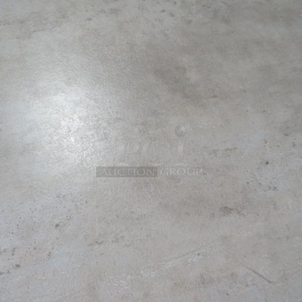Gray table top, 48x30 inches, on dual pedestal bases. Smooth surface, good condition, ideal for office or home use.