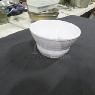 One white GET B-10-MN melamine ramekin, 4.5x2 inches, in used condition on a dark surface.