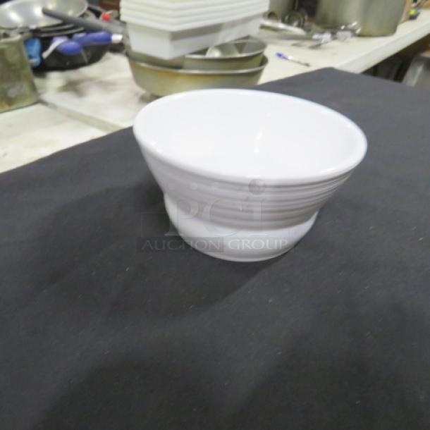 One GET Melamine Ramekin, model B-10-MN, 4.5x2 inches, white, visible in good condition on a dark surface.