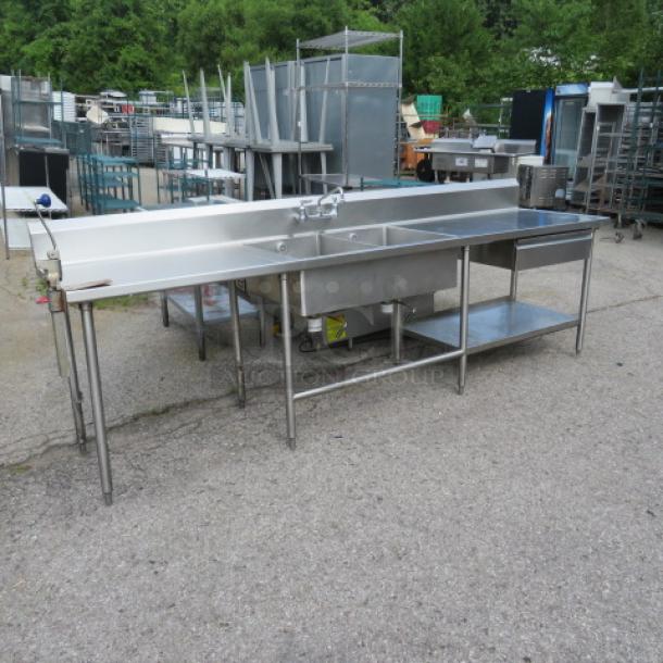 Stainless steel 2-compartment sink with faucet, right/left drain tables, Edlund 10lb can opener, drawer, backsplash, and under shelf, 120x30x42 inches.