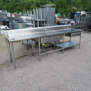 Stainless steel 2-compartment sink with faucet, right/left drain tables, Edlund 10lb can opener, drawer, backsplash, and under shelf, 120x30x42 inches.