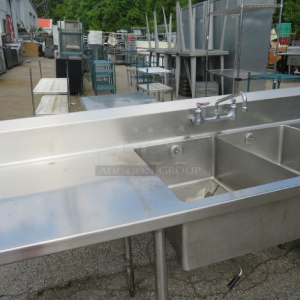 Stainless steel 2-compartment sink with faucet, right/left drain tables, Edlund 10lb can opener, backsplash, and undershelf. 120x30x42 inches.