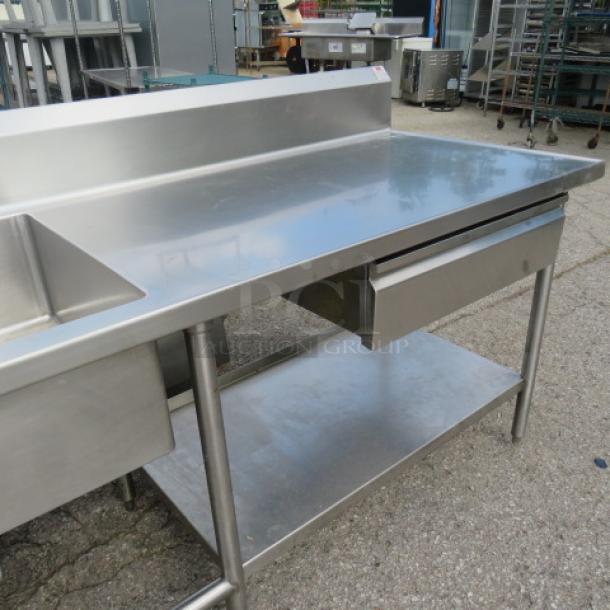 Stainless steel 2-compartment sink with faucet, right/left drain tables, Edlund can opener, drawer, backsplash, under shelf.