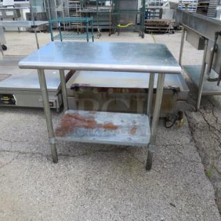 Stainless steel table with under shelf, dimensions 36Wx24Dx34H inches, showing signs of wear and rust on the shelf.