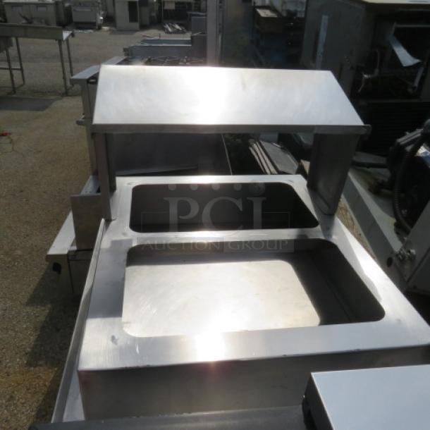 Stainless steel equipment tabletop holder, 31x25x21 inches, dual openings, polished surface, durable condition.