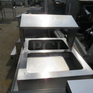 Stainless steel equipment tabletop holder, 31x25x21 inches, dual openings, polished surface, durable condition.