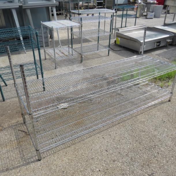 Metal Metro shelf with two wire shelves, dimensions 72x24x35 inches. Sturdy construction, used condition, ideal for storage.