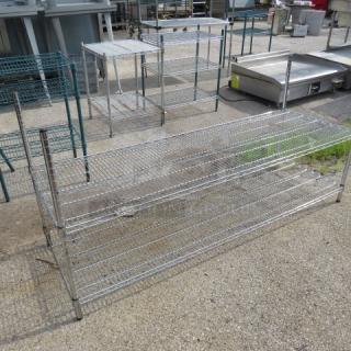 Metal Metro shelf with two wire shelves, dimensions 72x24x35 inches. Sturdy construction, used condition, ideal for storage.