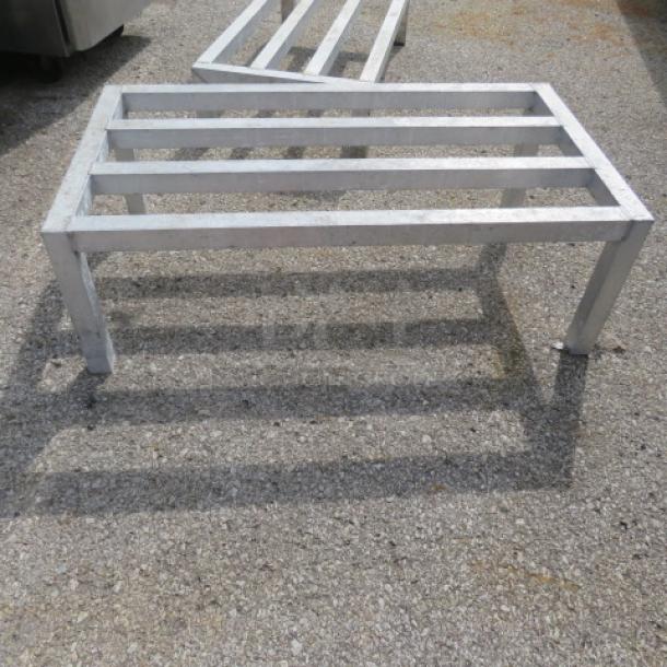 Aluminum dunnage rack, size 36x20x12 inches, featuring a slatted top and sturdy legs. Suitable for storage, used condition.