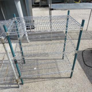 Green Metro shelf unit with three wire shelves, measuring 30x18x35 inches. Sturdy condition, suitable for storage.