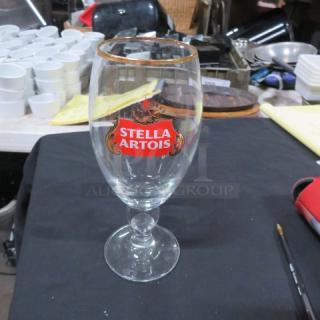 Stella Artois stem glass with gold rim, logo prominently displayed, in excellent condition, ideal for collectors.