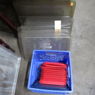Assorted food storage lids in large lot; includes red and transparent lids in various shapes and sizes, used condition.