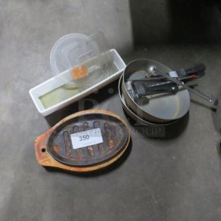 Lot of miscellaneous kitchen items including a metal pot, plastic containers, utensils, and a cast iron grill with number 350 tag.