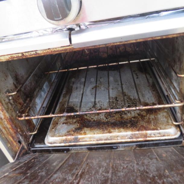 Sunfire 4 Burner Natural Gas Range Model X24-4L. Includes 1 rack, SS overshelf, on casters. Shows signs of use. 23.5x33.5x56.