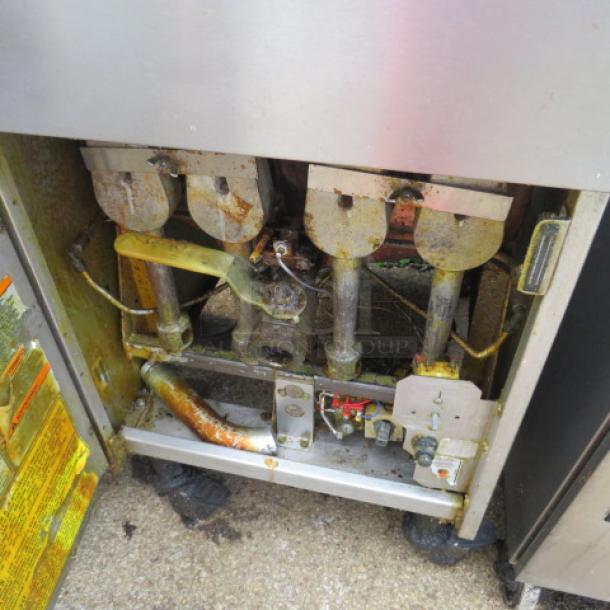 Anets SLG100 natural gas deep fryer with one basket, on casters. Dimensions: 20x37x48. Visible wear and maintenance labels present.