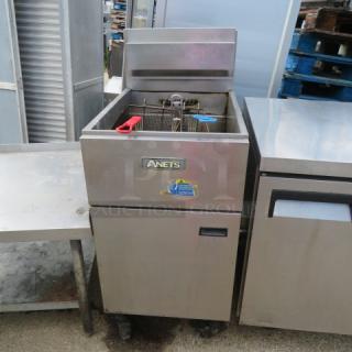 Anets SLG100 natural gas deep fryer with one basket, on casters. Stainless steel, shows label, measures 20x37x48 inches.