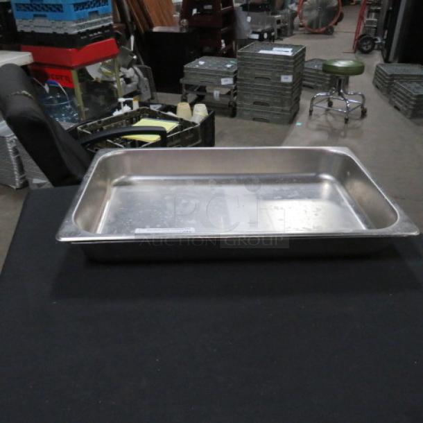 Full-size stainless steel hotel pan, 2.5-inch deep, in used condition, suitable for catering or food service.
