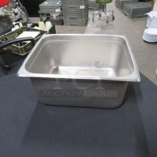 Half-size 6-inch deep hotel pan, stainless steel, used condition, ideal for commercial kitchen use.
