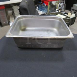 Half size, 4-inch deep hotel pan, stainless steel, used condition, shows signs of wear, ideal for commercial kitchen use.