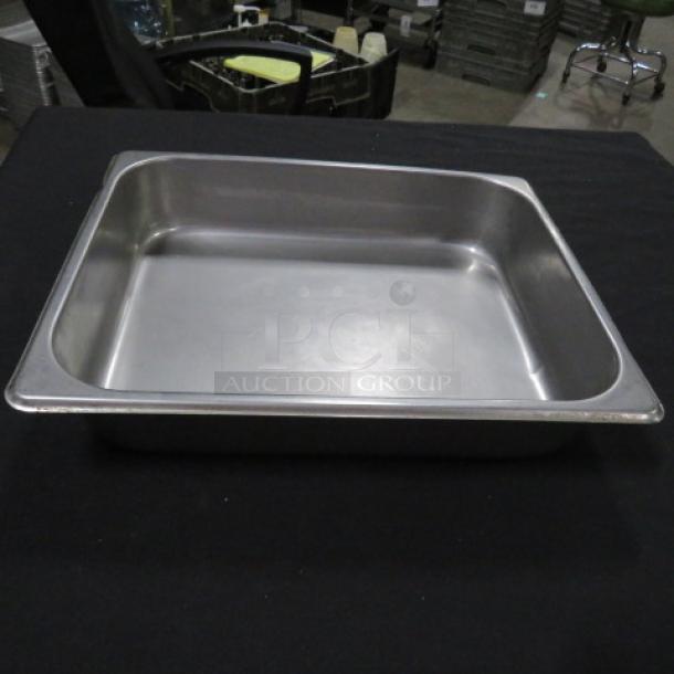 Half size, 2.5-inch deep stainless steel hotel pan in excellent condition, ideal for commercial kitchen use.