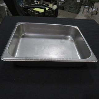 Half size, 2.5-inch deep stainless steel hotel pan in excellent condition, ideal for commercial kitchen use.