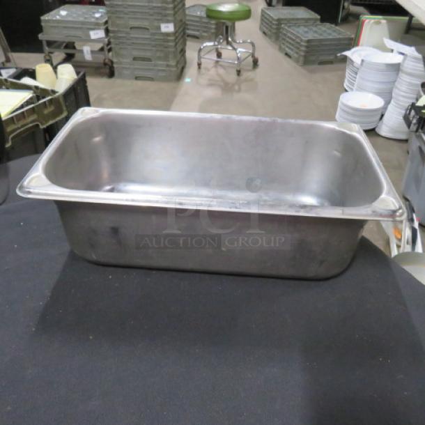 1/3 size, 4-inch deep hotel pan in metal. Used condition, visible surface wear. Ideal for catering or food service.