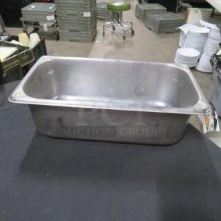 1/3 size, 4-inch deep hotel pan in metal. Used condition, visible surface wear. Ideal for catering or food service.