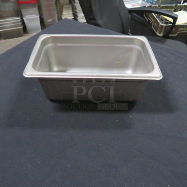 1/4 size 4-inch deep hotel pan, stainless steel, good condition, ideal for food service use.
