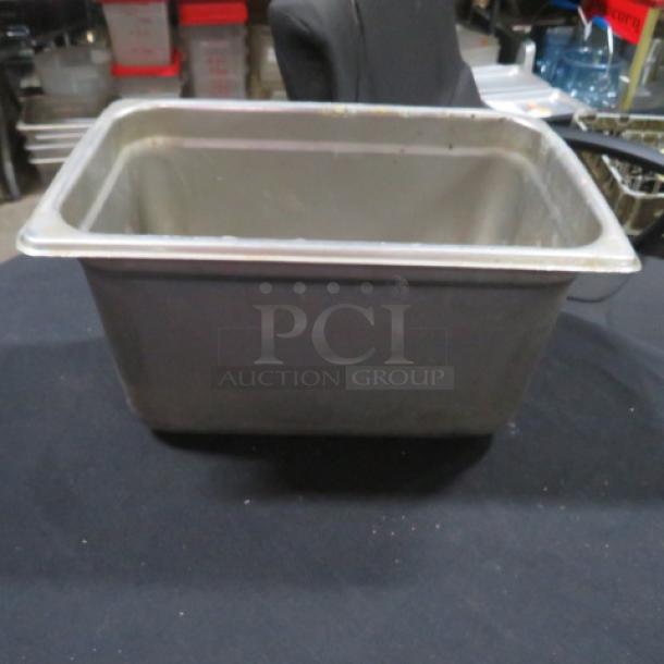 1/4 Size 6 Inch Deep Hotel Pan, metal construction, used condition with visible wear, ideal for catering or food service.