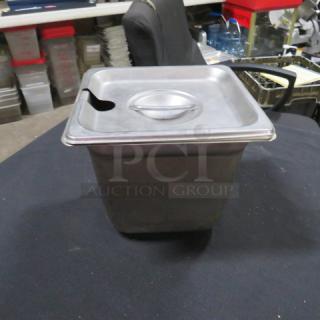 1/6 size, 6-inch deep stainless steel hotel pan with lid; features a spoon slot; used condition.